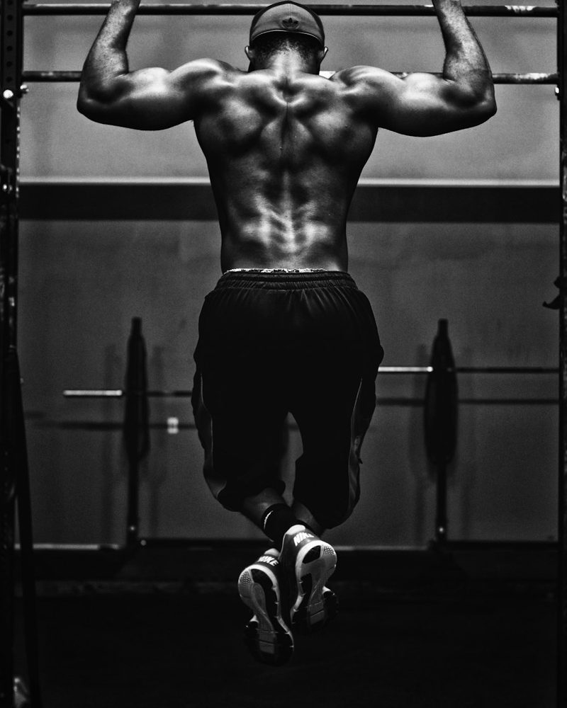 Athlete doing pull-ups in a gym